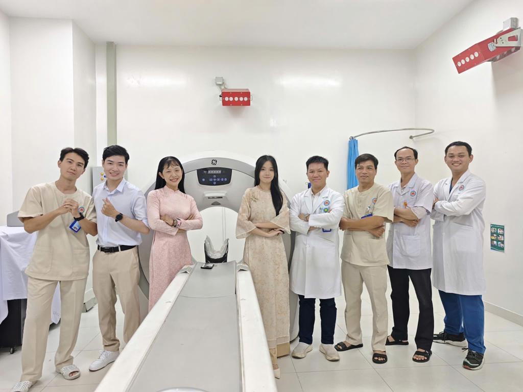 A group of people standing in a room with a machine

AI-generated content may be incorrect.
